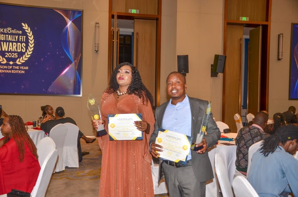 Lewis Syomane with a certificate and trophy at the awards ceremony